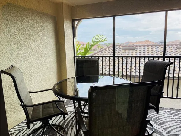a view of a chair and table in the balcony