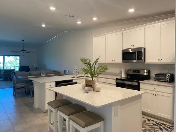 a kitchen with a sink a stove and cabinets