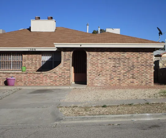 a front view of a house with a road