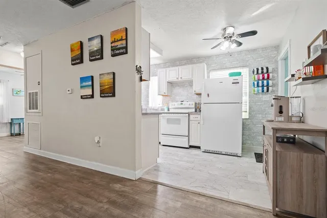 a kitchen with cabinets and wooden floor