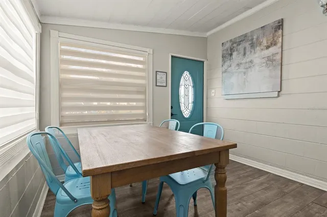 a view of a dining room with furniture and window