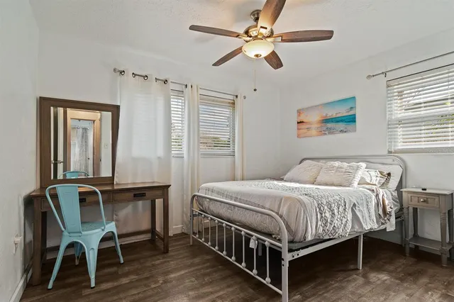 a bedroom with a bed desk and a window