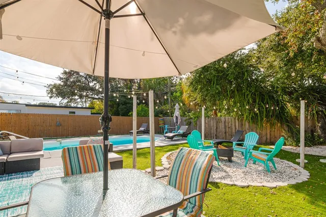 a view of backyard with seating area and green space