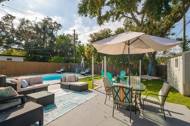 a view of a swimming pool with chairs in patio