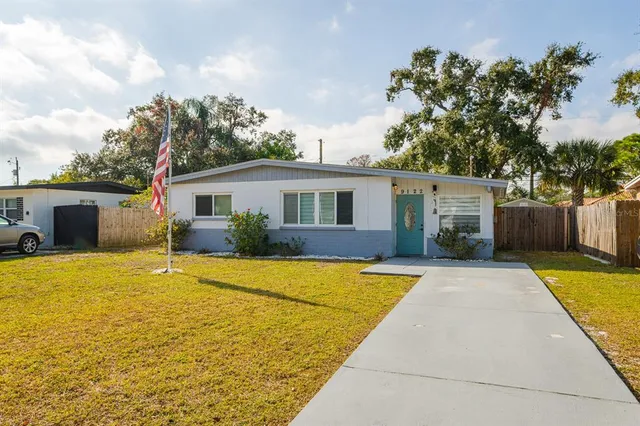 an aerial view of swimming pool with a yard and mountain view in back