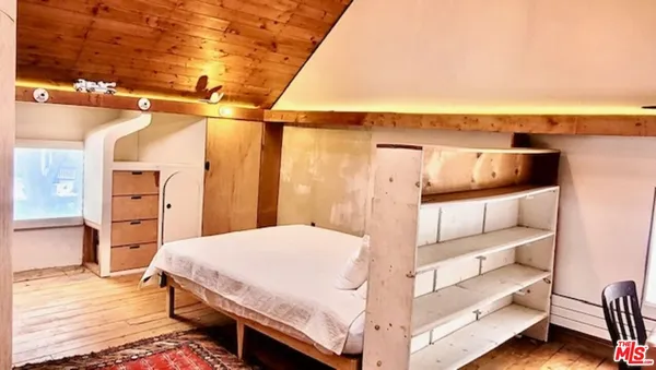 a bedroom with a bed and a night stand