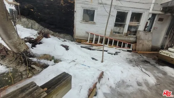 a view of a house with wooden fence
