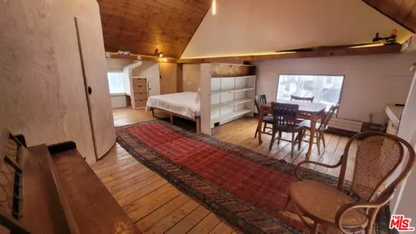 a bedroom with furniture and a window