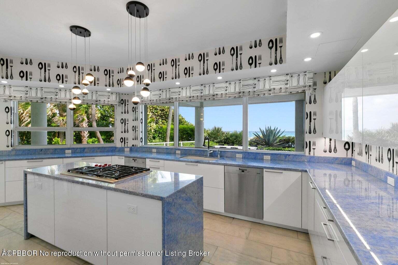 619 South Beach Road Hobe Sound, FL 33455 - Photo 11 of 23 a kitchen with kitchen island stainless steel appliances a sink stove and window