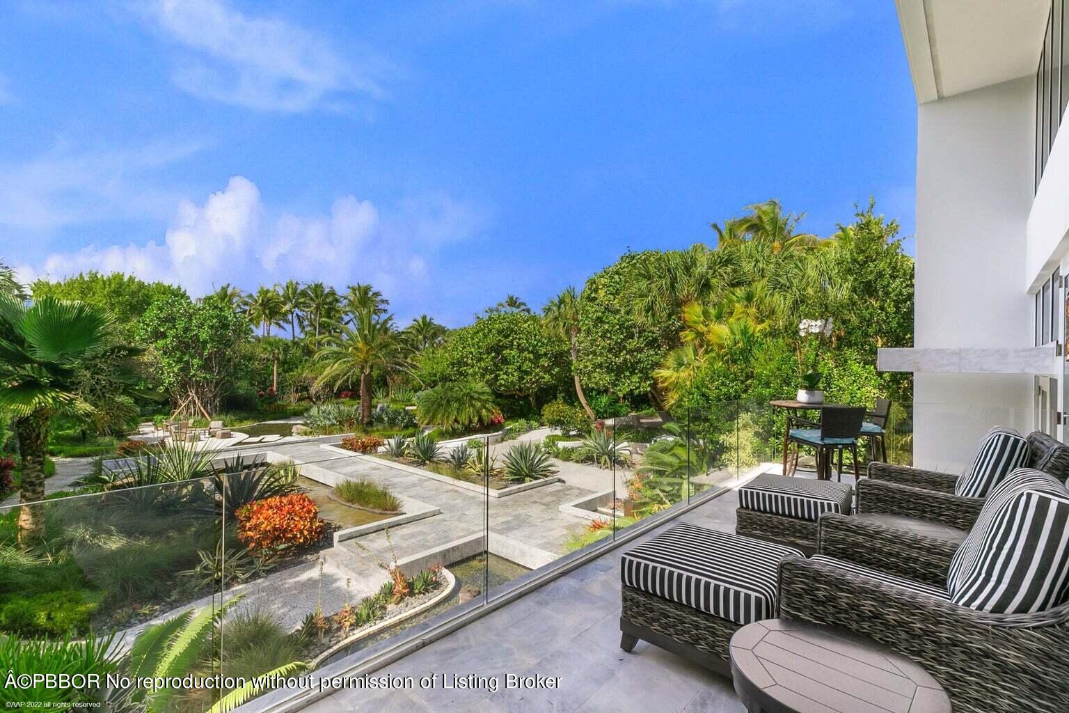 619 South Beach Road Hobe Sound, FL 33455 - Photo 20 of 23 a view of a patio with couches table and chairs under an umbrella