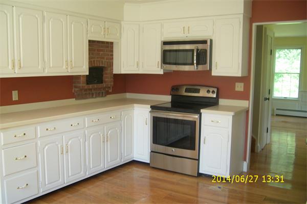 55 Ridge Road Rutland, MA 01543 - Photo 8 of 24 a kitchen with stainless steel appliances granite countertop a stove a microwave and oven
