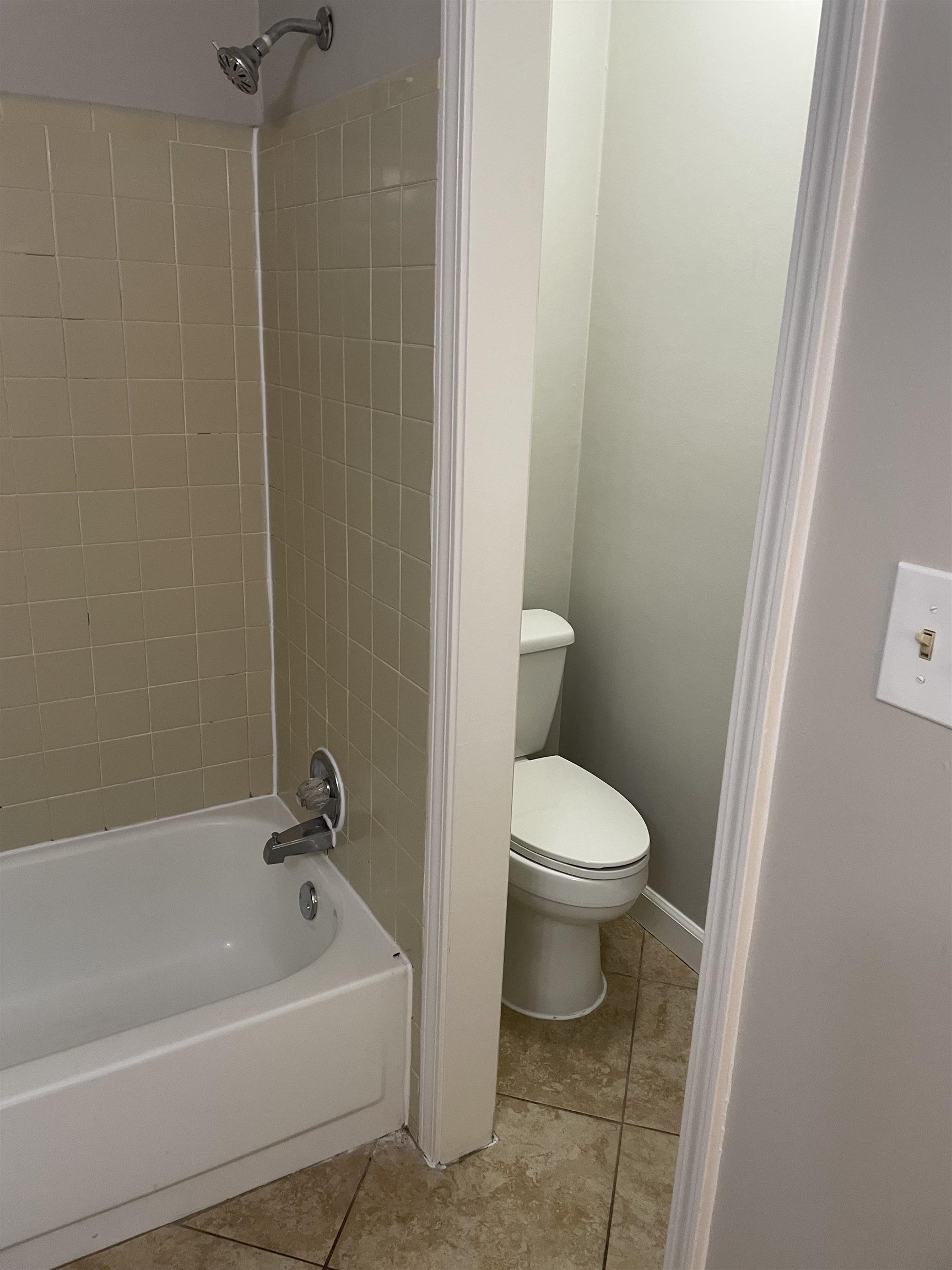 242 South Walnut Bend Road Memphis, TN 38018 - Photo 11 of 17 Bathroom with tile patterned floors, tiled shower / bath combo, and toilet