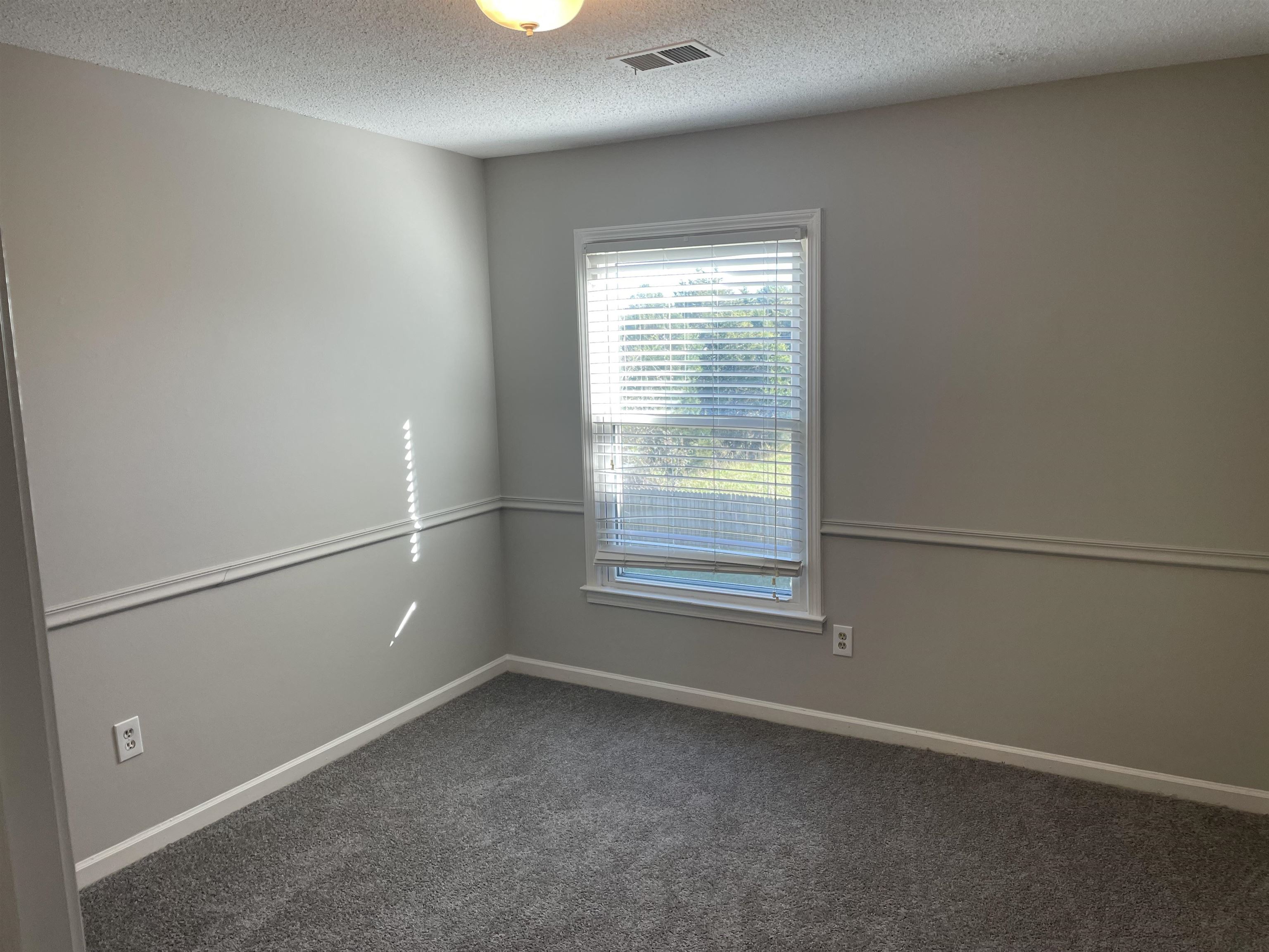 242 South Walnut Bend Road Memphis, TN 38018 - Photo 17 of 17 Unfurnished room featuring dark colored carpet and a textured ceiling