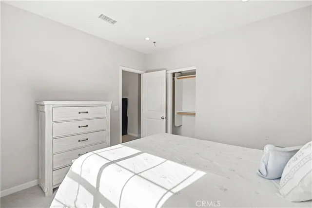 a bedroom with a bed and closet