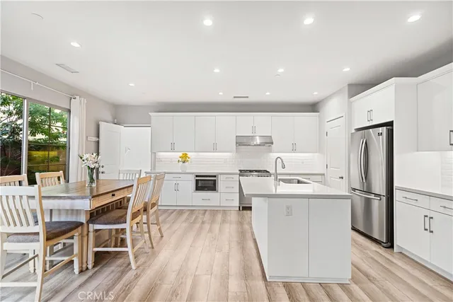 a view of a kitchen with dining table and chairs