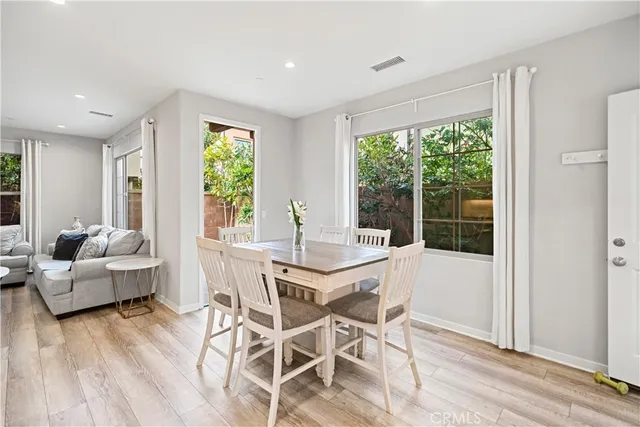 a dining room with furniture and wooden floor