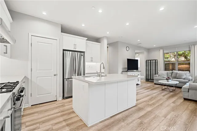 a view of kitchen with stainless steel appliances refrigerator stove and oven