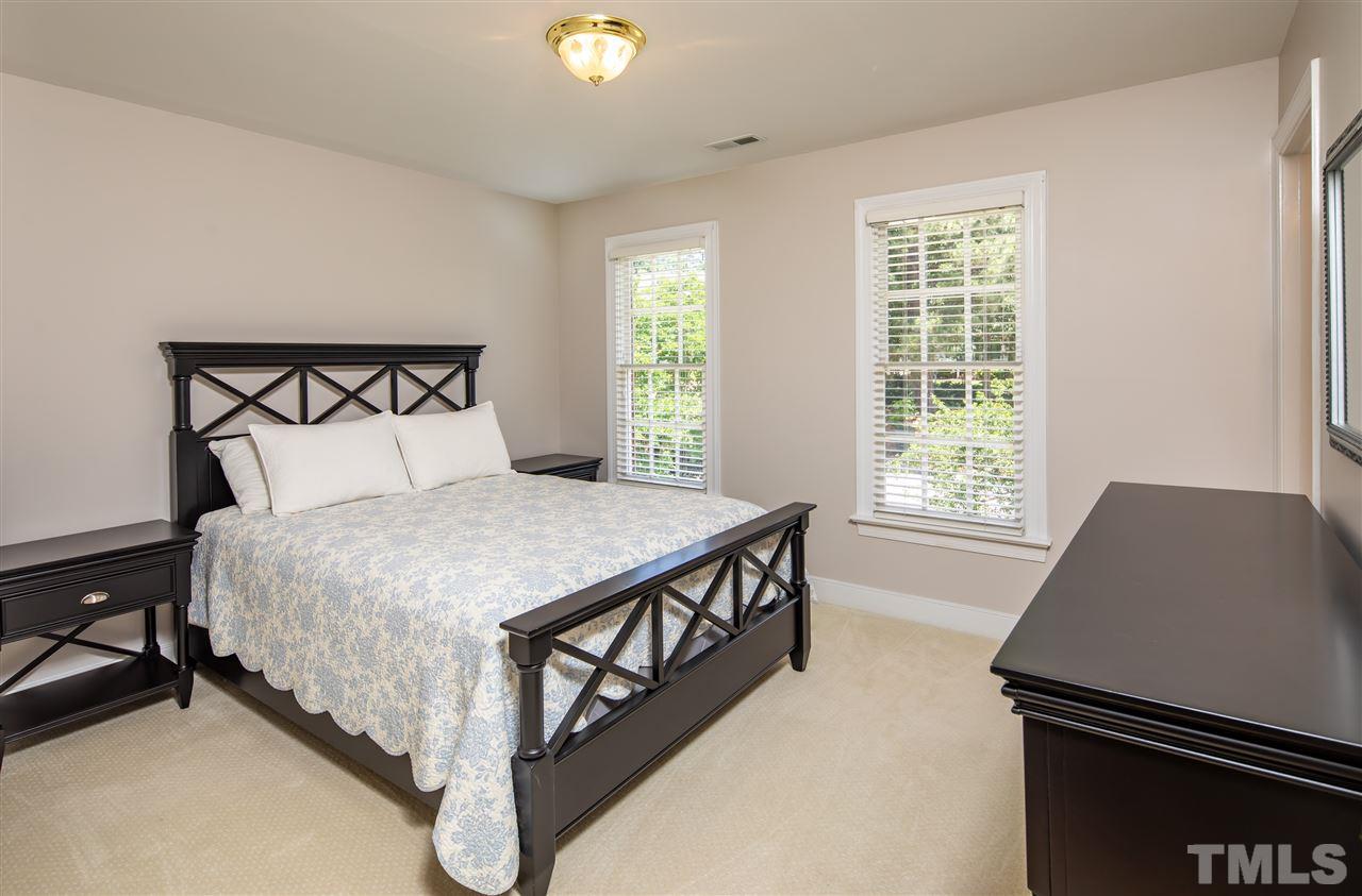 2709 Amstel Way Raleigh, NC 27613 - Photo 22 of 30 a large bed sitting in a bedroom next to a window