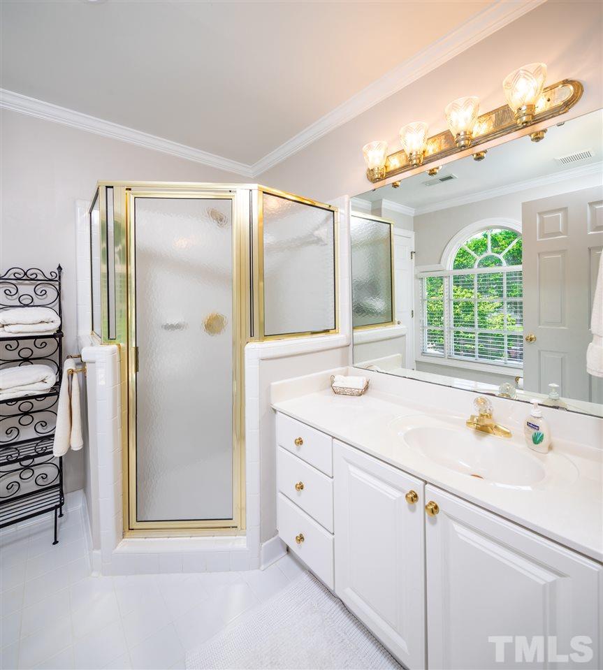 2709 Amstel Way Raleigh, NC 27613 - Photo 23 of 30 a bathroom with a tub a sink and a large mirror