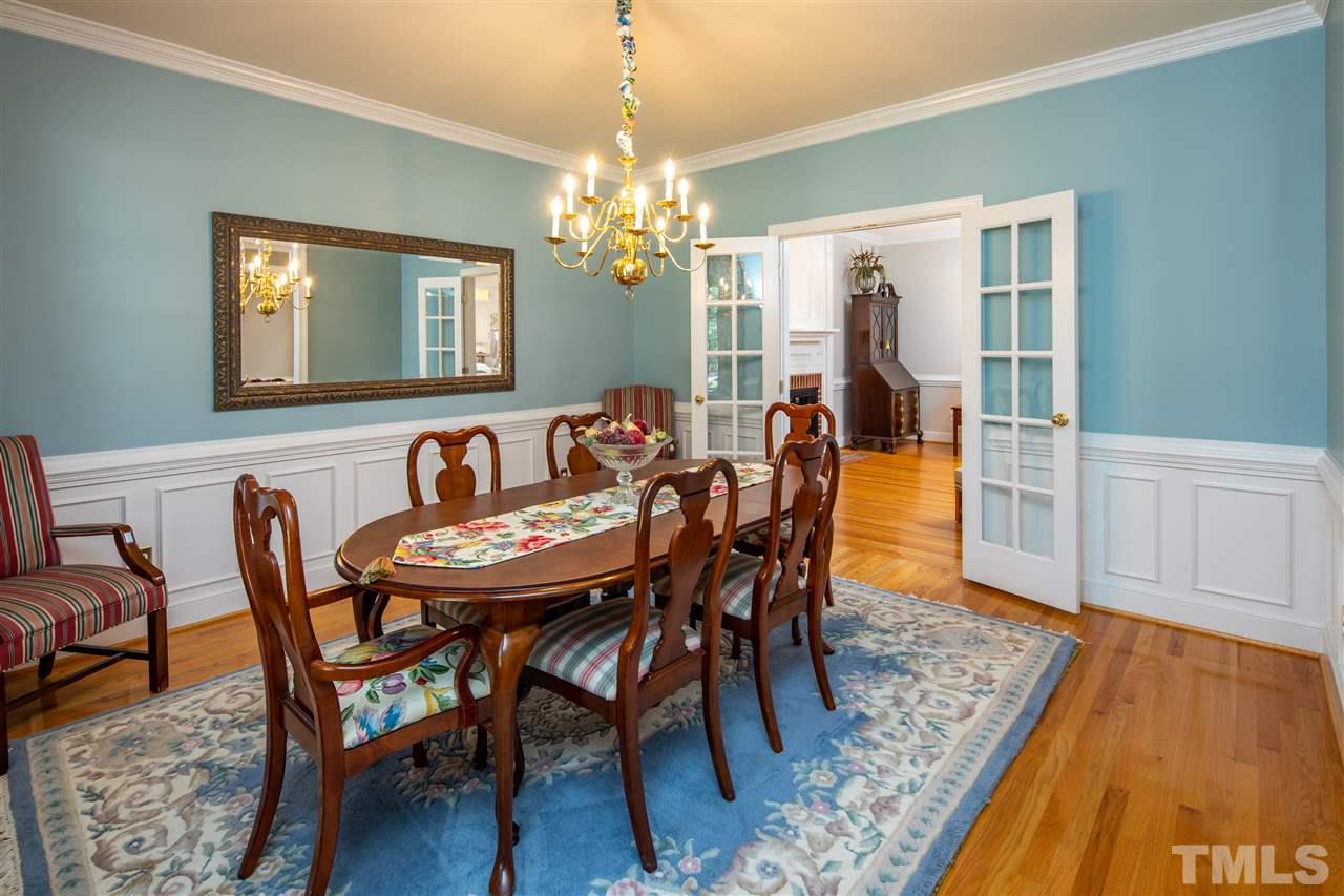 2709 Amstel Way Raleigh, NC 27613 - Photo 5 of 30 a dining room with furniture a chandelier and wooden floor