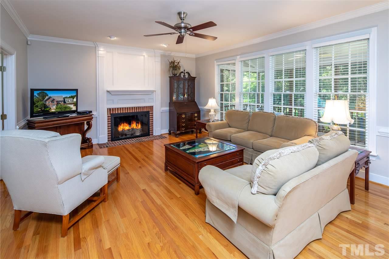 2709 Amstel Way Raleigh, NC 27613 - Photo 6 of 30 a living room with furniture fireplace and a flat screen tv