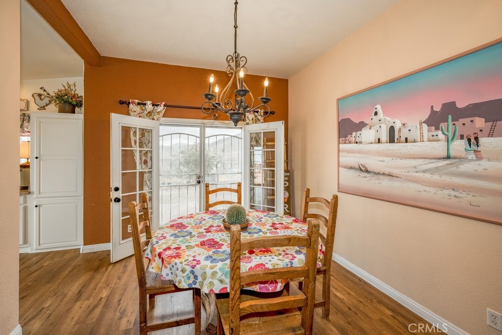 33330 Palen Road Agua Dulce, CA 91390 - Photo 21 of 56 a view of a dining room with furniture a chandelier and wooden floor