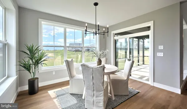 a view of a dining room with furniture window and wooden floor