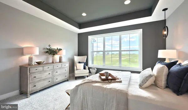 a bedroom with a bed and large windows