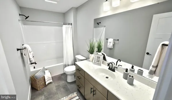 a bathroom with a double vanity sink toilet and shower