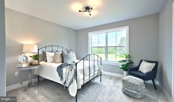 a bed room with a bed and a chair