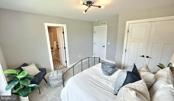 a bedroom with a bed and a chandelier