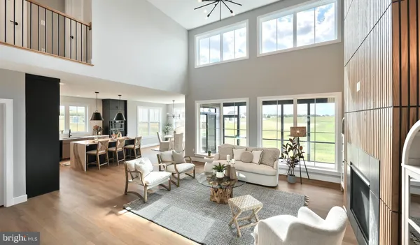 a living room with furniture large window and a fireplace