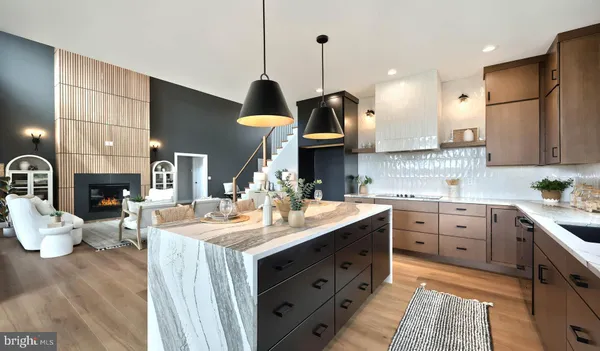 a kitchen with stainless steel appliances granite countertop a sink a stove and a wooden floors