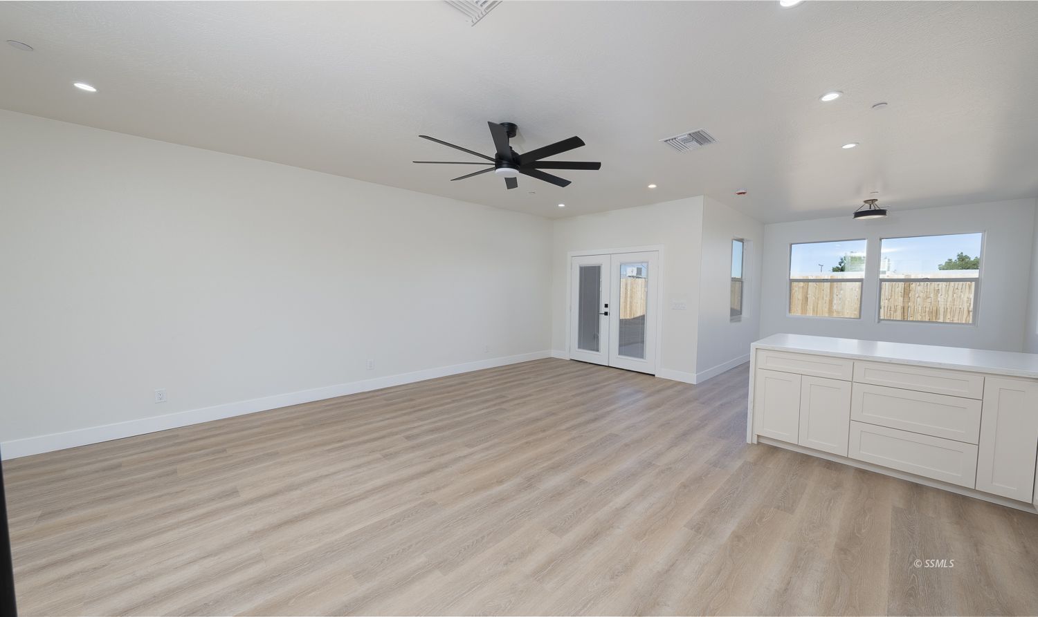 1528 Mayo Street Ridgecrest, CA 93555 - Photo 11 of 34 wooden floor in an empty room with a window