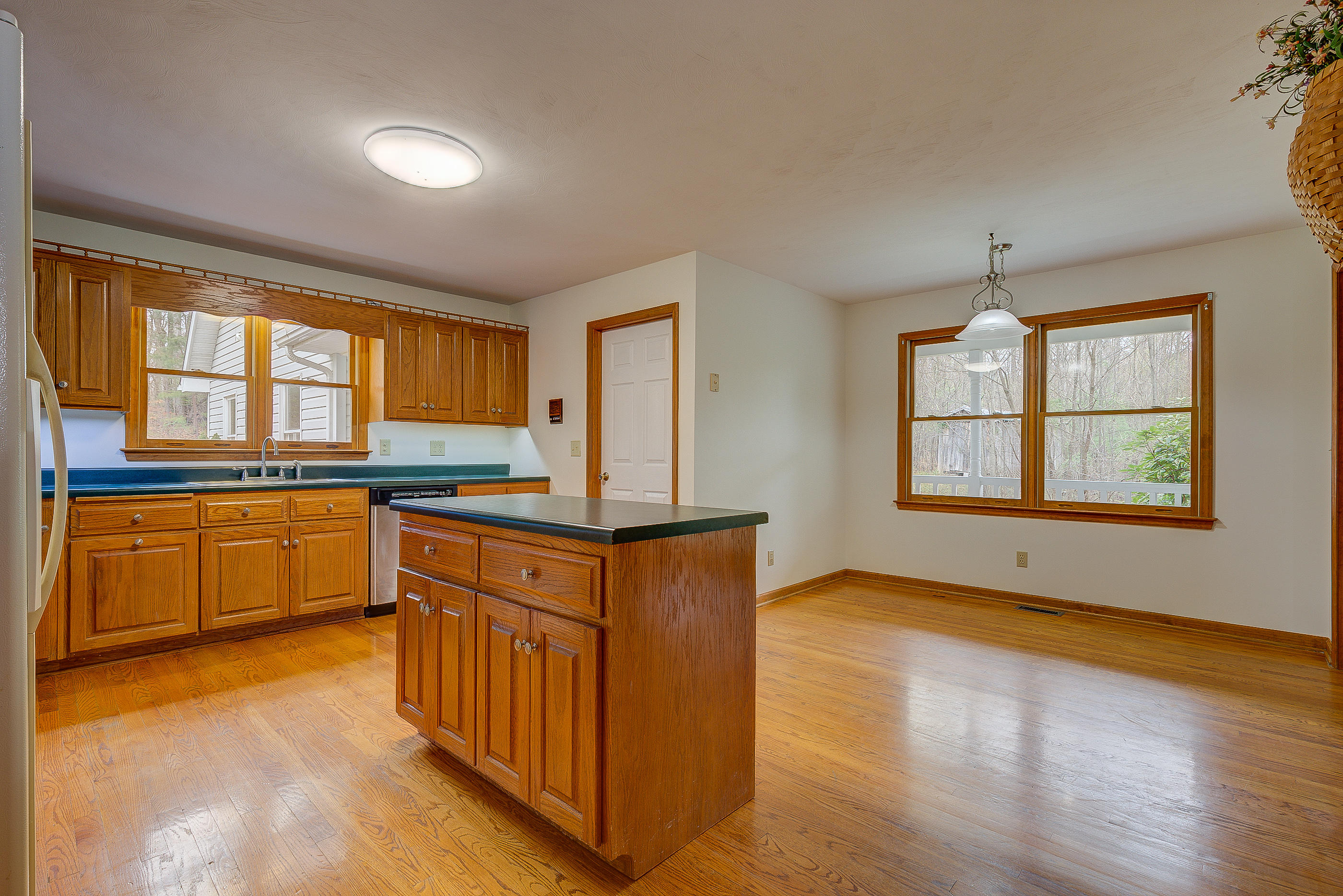 224 Shade Hollow Road Blue Ridge, VA 24064 - Photo 11 of 38 a kitchen with stainless steel appliances granite countertop white cabinets and wooden floor