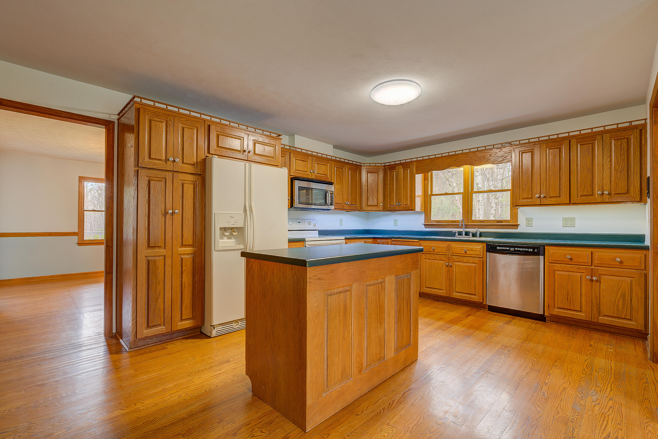 224 Shade Hollow Road Blue Ridge, VA 24064 - Photo 13 of 38 a kitchen with stainless steel appliances granite countertop a refrigerator a sink dishwasher stove and wooden cabinets with wooden floor
