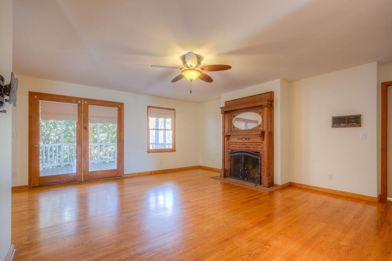 224 Shade Hollow Road Blue Ridge, VA 24064 - Photo 15 of 38 a view of empty room with a fireplace and wooden floor