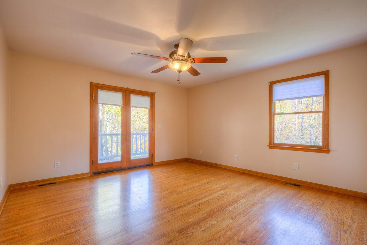 224 Shade Hollow Road Blue Ridge, VA 24064 - Photo 17 of 38 a view of empty room with wooden floor and fan