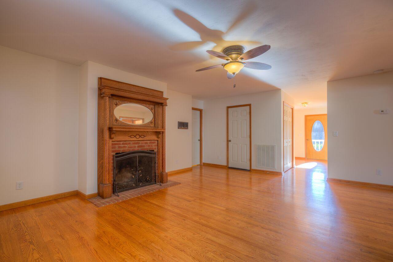 224 Shade Hollow Road Blue Ridge, VA 24064 - Photo 10 of 38 a view of empty room with a fireplace and wooden floor