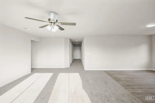a view of a kitchen with wooden floor and a window