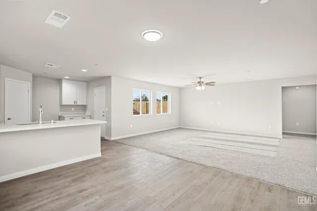a kitchen with kitchen island sink stove and white cabinets