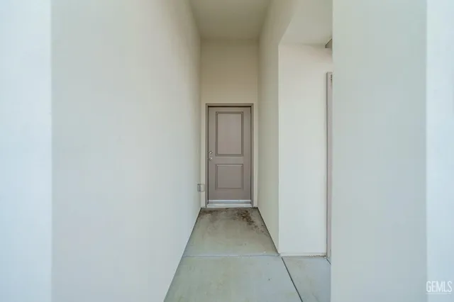 a view of a hallway with wooden floor and entryway