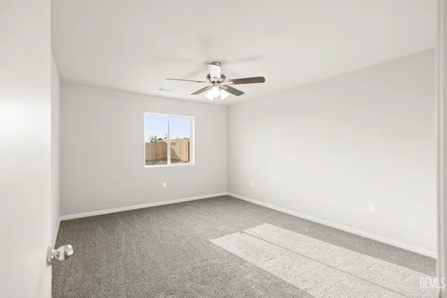a bathroom with a granite countertop sink a toilet and a large mirror