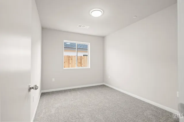 a view of an empty room with kitchen