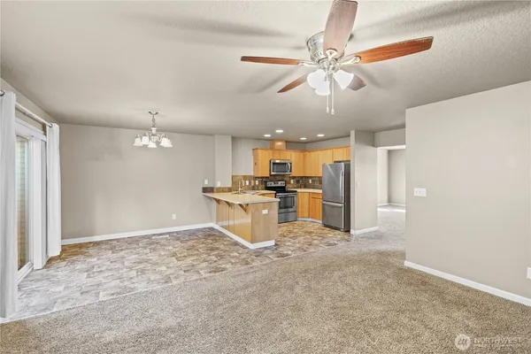 a kitchen with kitchen island a stove a refrigerator and a sink
