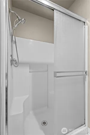 a bathroom with a glass shower door