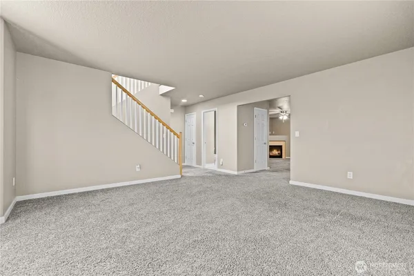 a view of an empty room with stairs