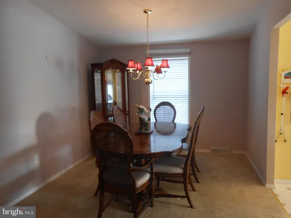 a kitchen with a refrigerator and cabinets