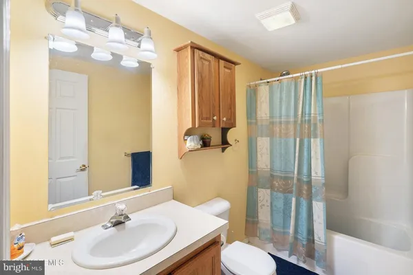 a view of walk in closet with clothes