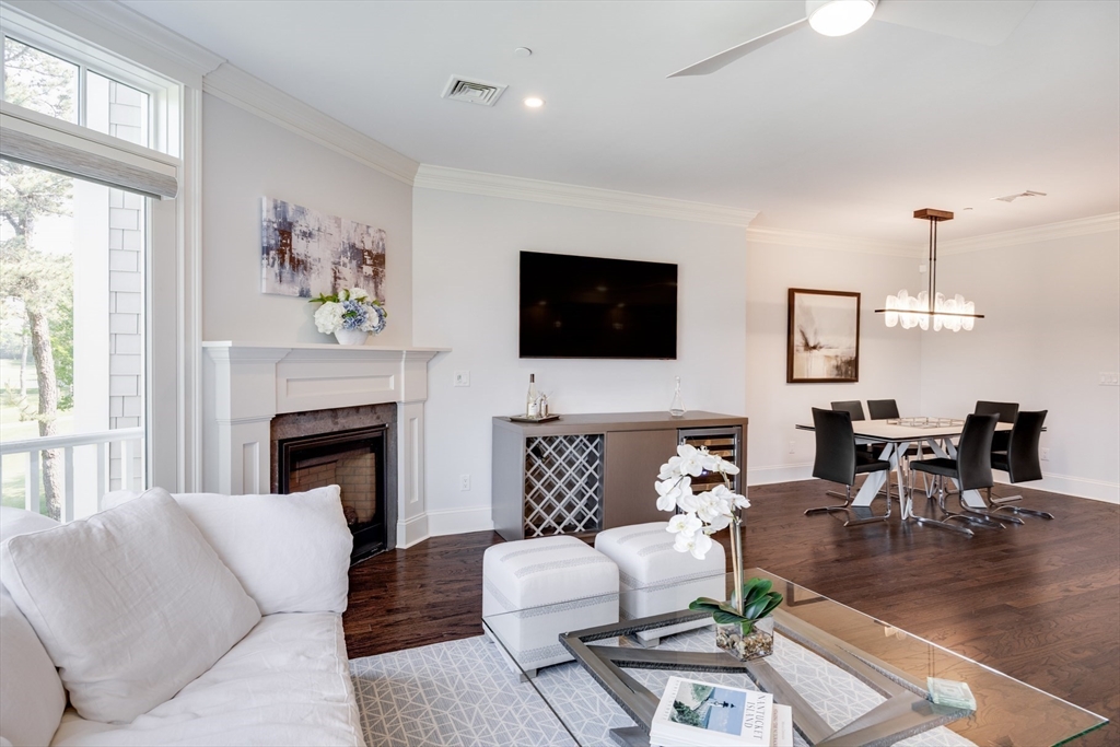 66 Simons Road, Unit C Mashpee, MA 02649 - Photo 15 of 42 a living room with furniture fireplace and window